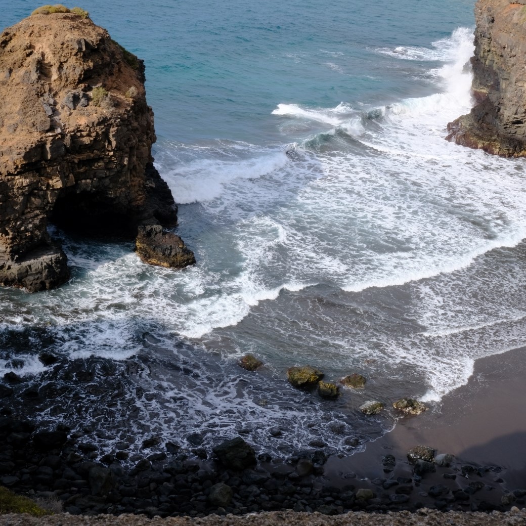 Photo of a wavy beach from a high vantage point